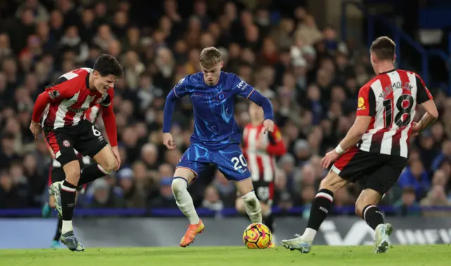 Cole Palmer of Chelsea is challenged by Christian Norgaard and Yehor Yarmolyuk of Brentford