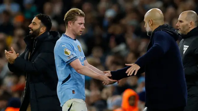 Manchester City's Kevin De Bruyne shakes hands with manager Pep Guardiola after he was substituted