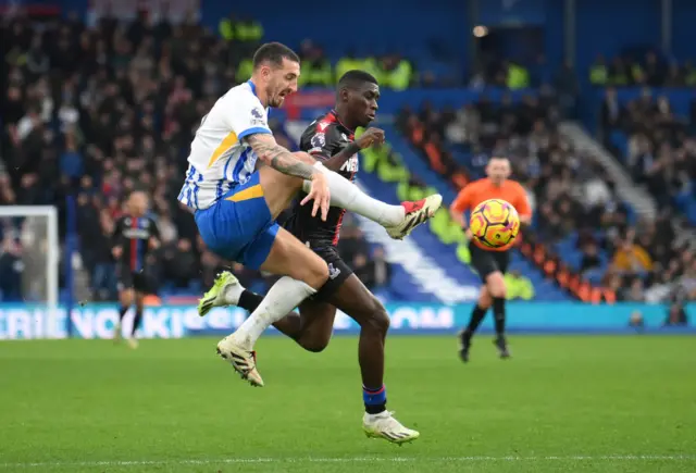 Lewis Dunk of Brighton & Hove Albion battles for possession with Ismaila Sarr of Crystal Palace