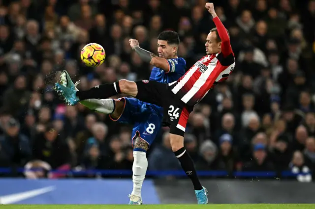 Enzo Fernandez battles for the ball with Brentford midfielder Mikkel Damsgaard