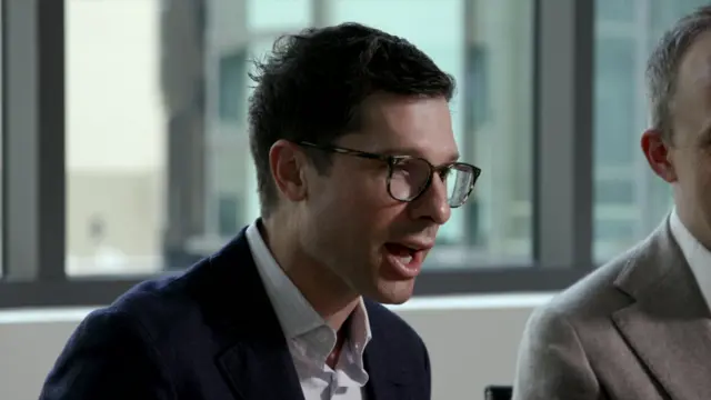 Clay Bavor speaking during interview, sitting in a room. Partial shot of Bret Taylor on right side