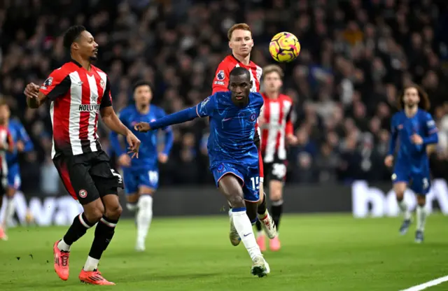 Nicolas Jackson of Chelsea is challenged by Ethan Pinnock of Brentford