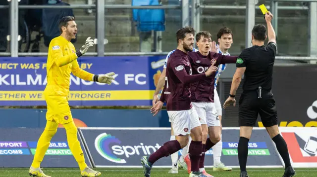 Hearts' James Penrice is shown a yellow card by referee Don Robertson after fouling Kilmarnock's Joe Wright and giving away a penalty during a William Hill Premiership match between Kilmanock and Heart of Midlothian at Rugby Park