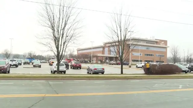 Vehicles parked outside the school building in a car park