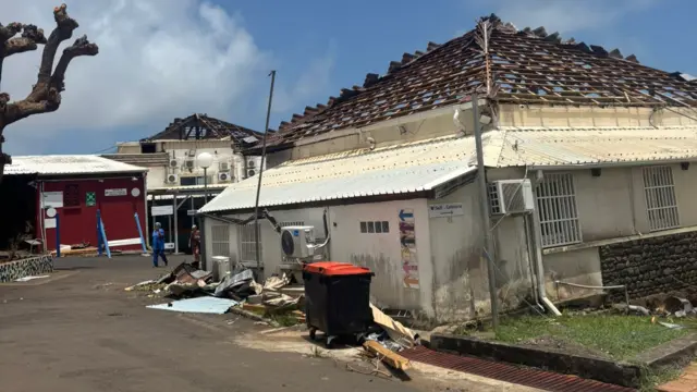 A roofless building surrounded by rubble