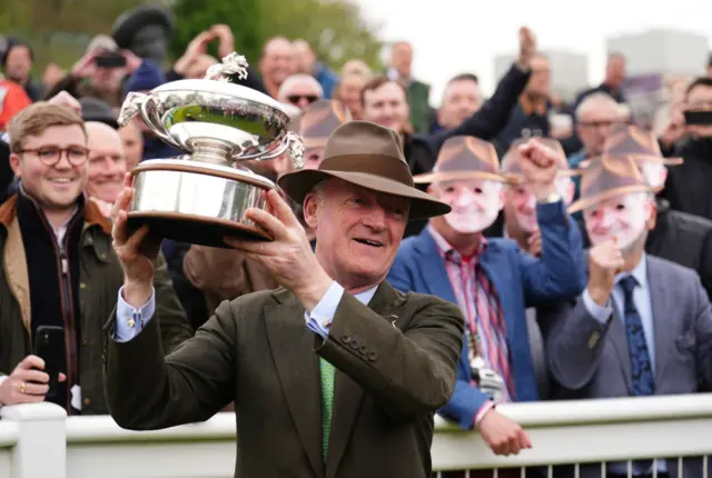 Willie Mullins lifts the British trainers' championship trophy at Sandown