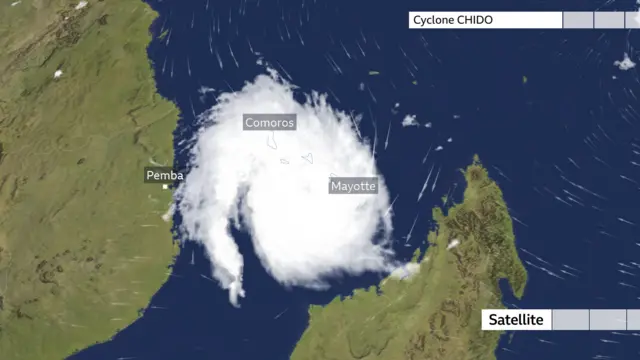 A satellite image shows the white spiral cloud of cyclone chido, stretching from the African coast to the coast of Madagascar, with Mayotte outlined in the middle of it