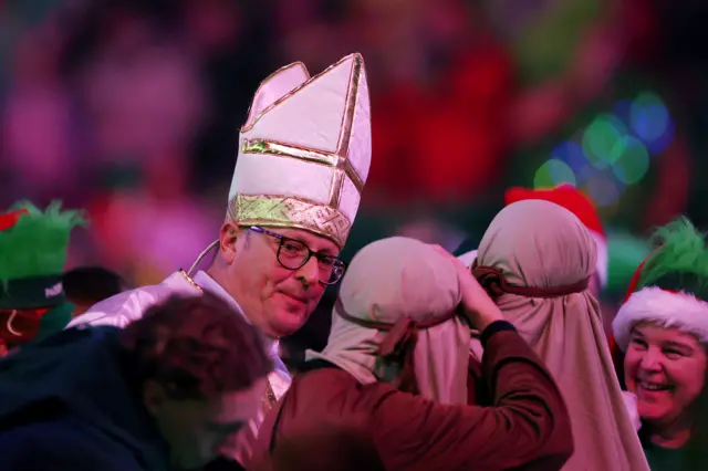 A spectator dressed as the Pope