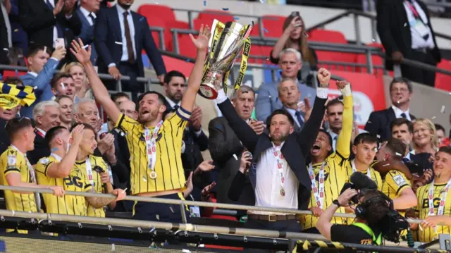 Des Buckingham lifts League One play-off trophy at Wembley