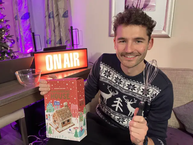 Charlie with a Gingerbread kit and a whisk.