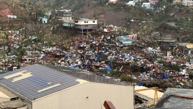 A photo taken on 15 December shows a pile of debris of metal sheets, wood, furniture and belongings after the cyclone Chido hit Mayotte