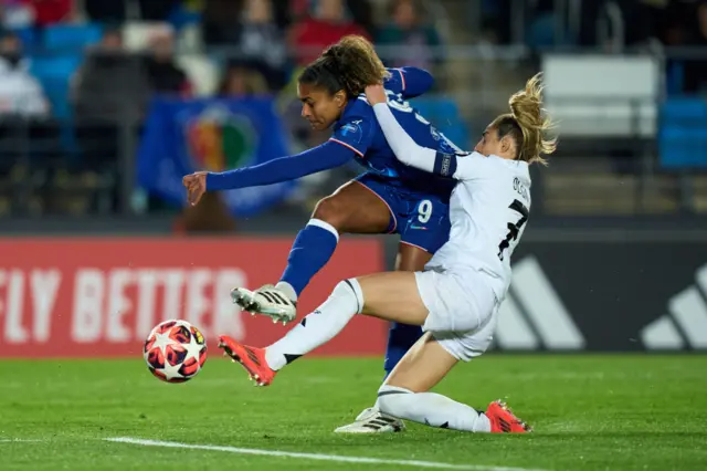 Catarina Macario of Chelsea FC takes a shot whilst under pressure from Olga Carmona