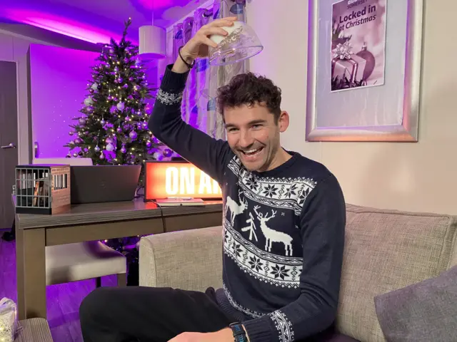 Charlie Taylor holding a bowl with whipped egg white above his head