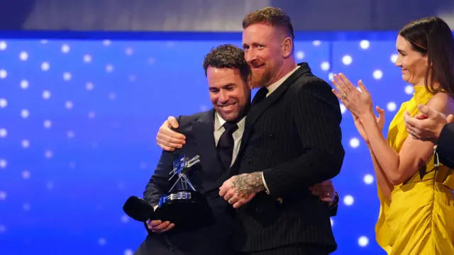 Sir Mark Cavendish (left) receives the BBC Sports Personality Lifetime Achievement Award from Sir Bradley Wiggins