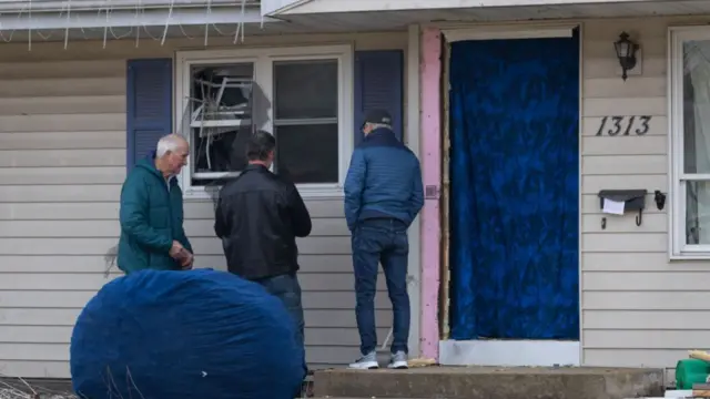 Workers seen repairing the damaged home