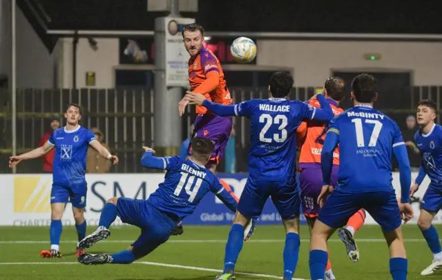 Linfield's Sam Roscoe rises highest to get his head to the ball against Dungannon