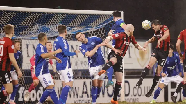 Philip Lowry heads Crusaders into the lead against the Lurgan Blues