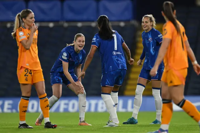 Nusken celebrates her goal with teammates as Madrid players look dejected