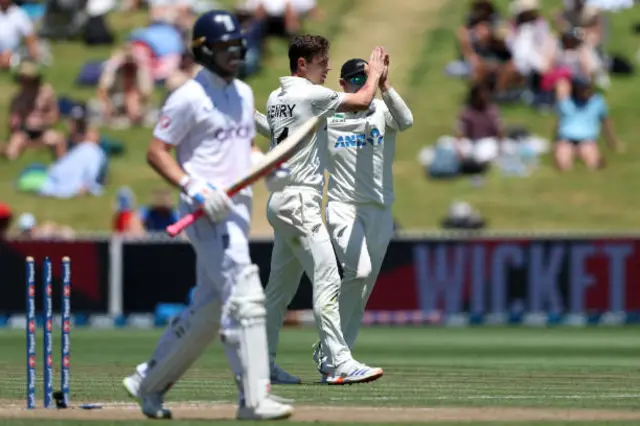 Matt Henry of New Zealand celebrates with Tom Latham after dismissing Ollie Pope