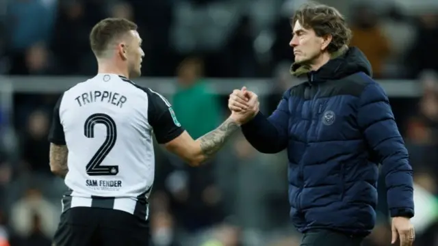 Kieran Trippier of Newcastle United shakes hands with Thomas Frank