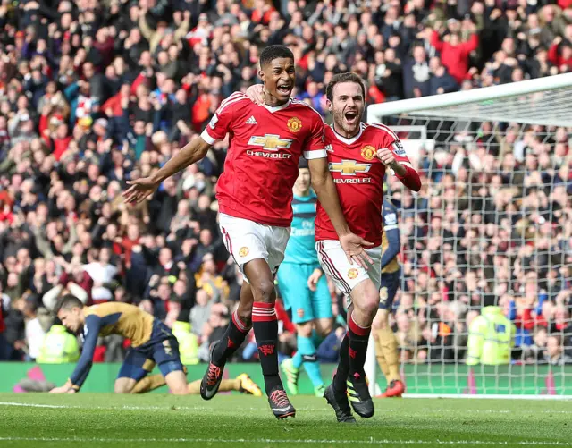 Marcus Rashford celebrates with Juan Mata after scoring on his debut