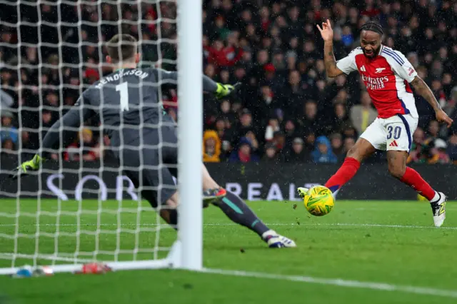 Raheem Sterling of Arsenal has a shot saved by Dean Henderson