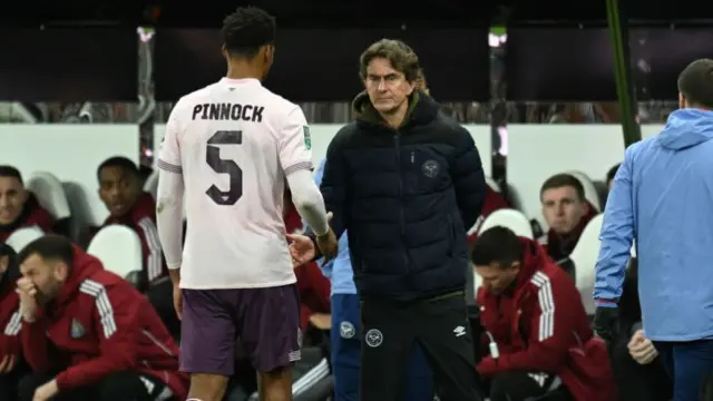 Thomas Frank, Manager of Brentford, consoles Ethan Pinnock