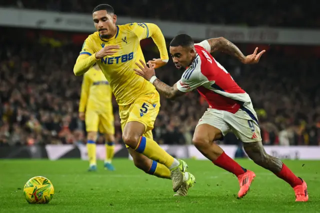 Maxence Lacroix  fights for the ball with Arsenal's Gabriel Jesus