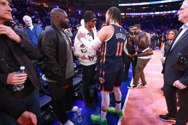 Marcus Rashford greets Jalen Brunson of the New York Knicks