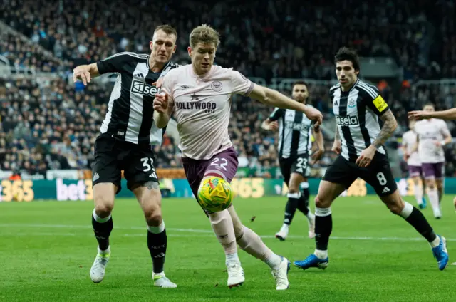 Dan Burn of Newcastle United and Nathan Collins of Brentford challenge