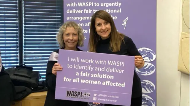 Secretary of State for Work and Pensions Liz Kendall holding a placard in support of the WASPI campaign