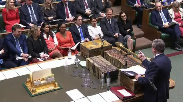 Starmer, standing at the dispatch box, points towards his opposition as he speaks