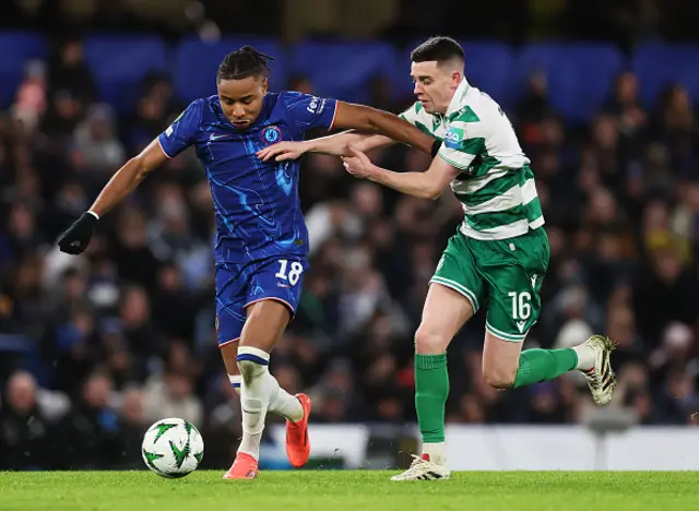 Christopher Nkunku of Chelsea controls the ball under pressure from Gary O'Neil