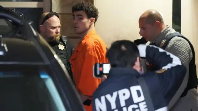 Luigi Nicholas Mangione (C), who has been accused of killing UnitedHealthcare CEO Brian Thompson, leaves after the hearing at Blair County Court House in Hollidaysburg, Pennsylvania