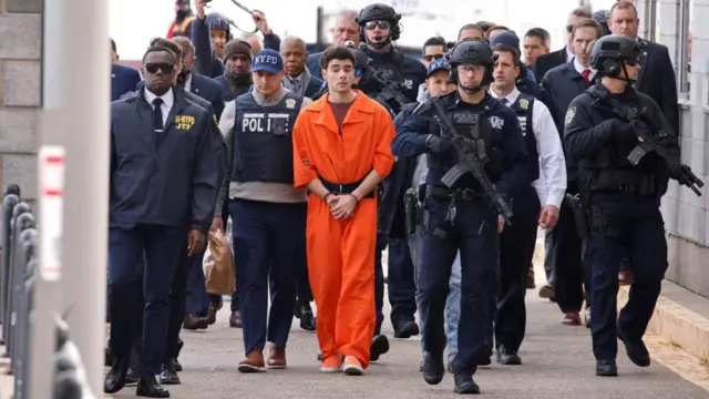 Luigi Mangione, the suspect in the murder of UnitedHealth Group executive Brian Thompson, arrives at a helicopter pad after being extradited from Pennsylvania