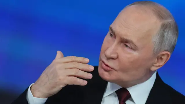 Putin gestures with his hand