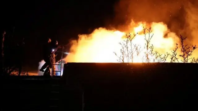 Ukrainian firefighters in Dnipro tackle a fire caused by Russia's Oreshnik missile last year