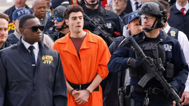 Luigi Mangione, the suspect in the murder of UnitedHealth Group executive Brian Thompson, arrives at a helicopter pad after being extradited from Pennsylvania, in New York