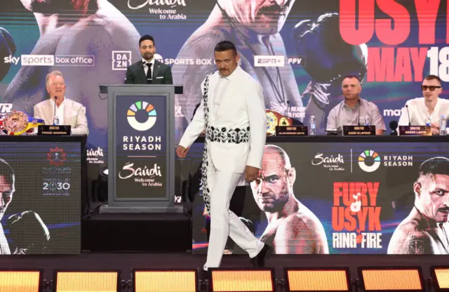 Oleksandr Usyk wearing a white suit