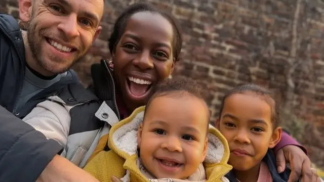 Family of mum, dad, small boy and girl. smiling in selfie