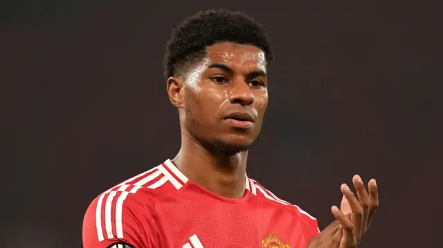 Marcus Rashford applauds Manchester United fans after a Europa League game