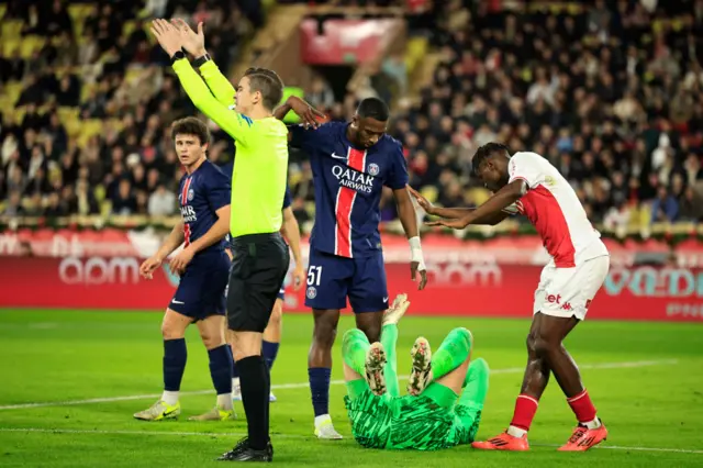 Wilfried Singo checks on Gianluigi Donnarumma