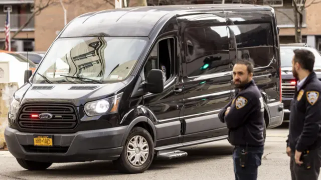 A blacked out van carries Luigi Mangione to court. He is not visible