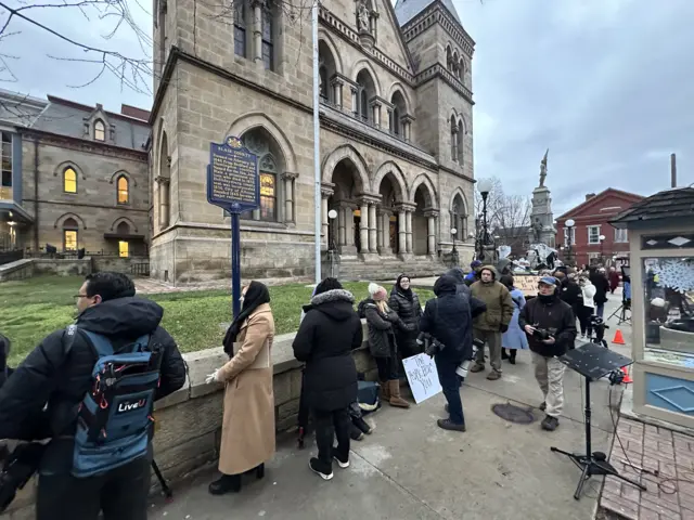 People stand in line outside the Pennsylvania courthouse where Luigi Mangione will appear