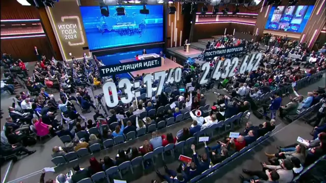 Ariel shot of an audience with a computer generated number graphic imposed above them