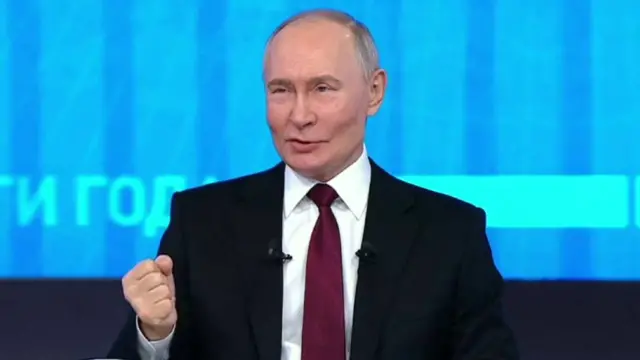 President Putin holds a fist while addressing the nation.