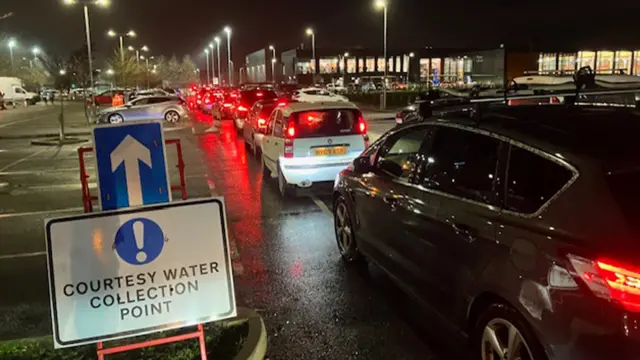 Cars queuing for water