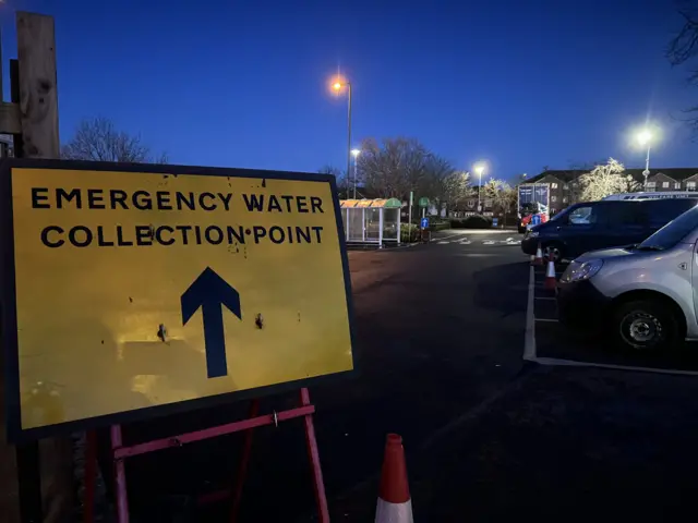 A yellow sign that says emergency collection point