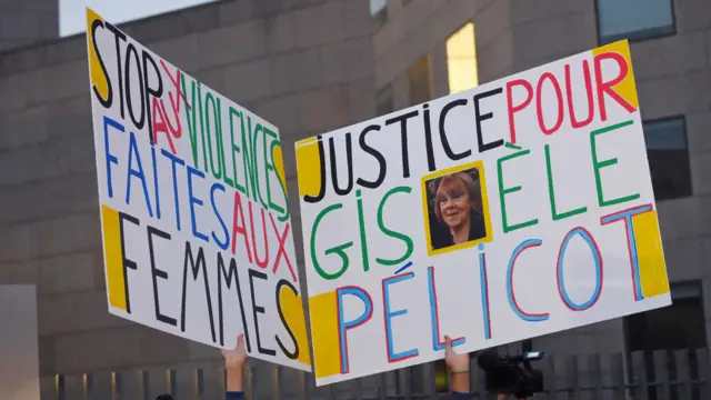 Two placards reading: "Stop violence against women" and "Justice for Gisele Pelicot"