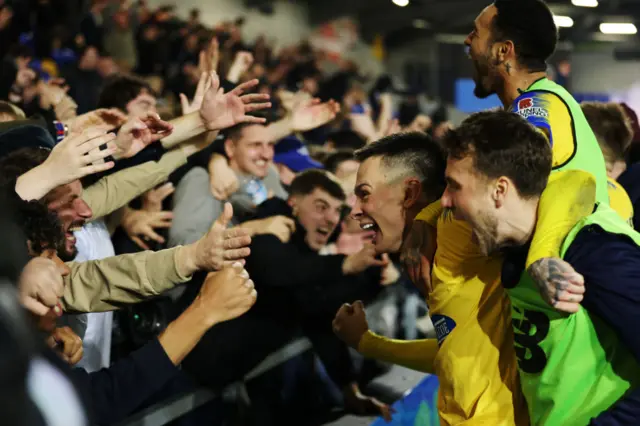 Ryan Alex Hill of Dagenham & Redbridge celebrates with the fans